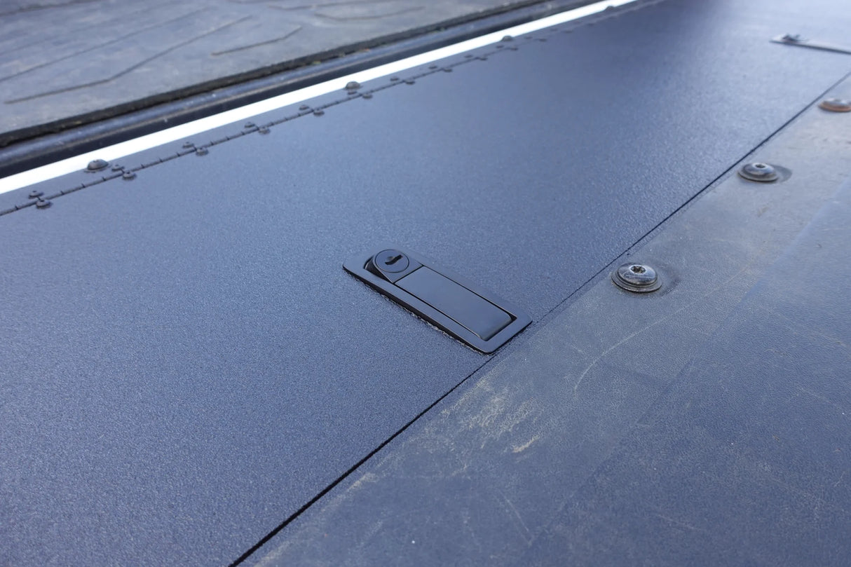Close-up of a textured metal surface with a small rectangular cutout.