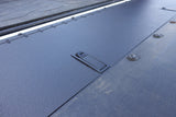 Close-up of a textured metal surface with a small rectangular cutout.