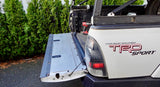 Toyota TRD Sport truck with an open tailgate in a driveway.