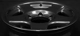 Face 1. Close-up of a shiny metallic rim on a black background