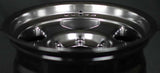 Face 4 Deep. Close-up of a shiny metallic wheel rim on a dark background