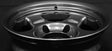 Face 4. Close-up of a shiny metal rim on a black background