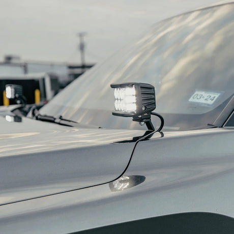 Car light mounted on a vehicle's hood with a blurred background