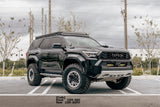 Black Toyota SUV with lifted suspension on a road
