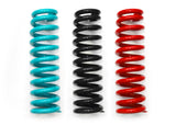 Three coil springs in teal, black, and red on a white background