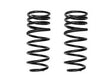 A pair of black rear coil springs for a vehicle.