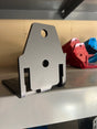 Metal bracket on a metal surface with tools in the background