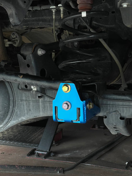 Blue metal component on a vehicle's undercarriage