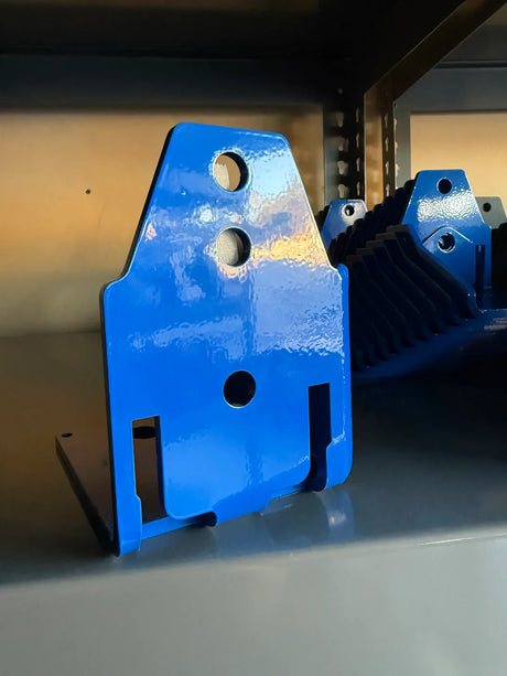 Blue metal bracket on a gray shelf with a blurred background