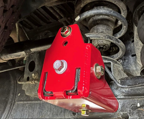 Red bracket on a vehicle's suspension system