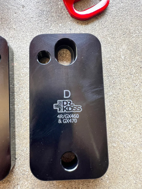 Black metal plate with branding on a gray surface