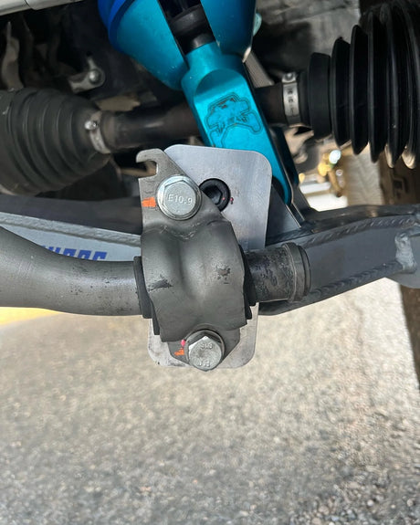 Close-up of a vehicle suspension system with blue and black components.