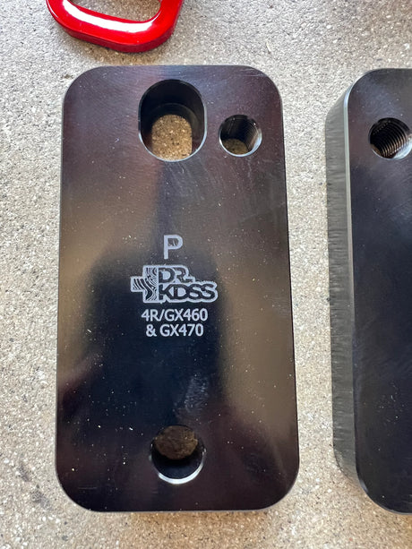 Metal bracket with 'Dr. KDSS' branding on a gray surface