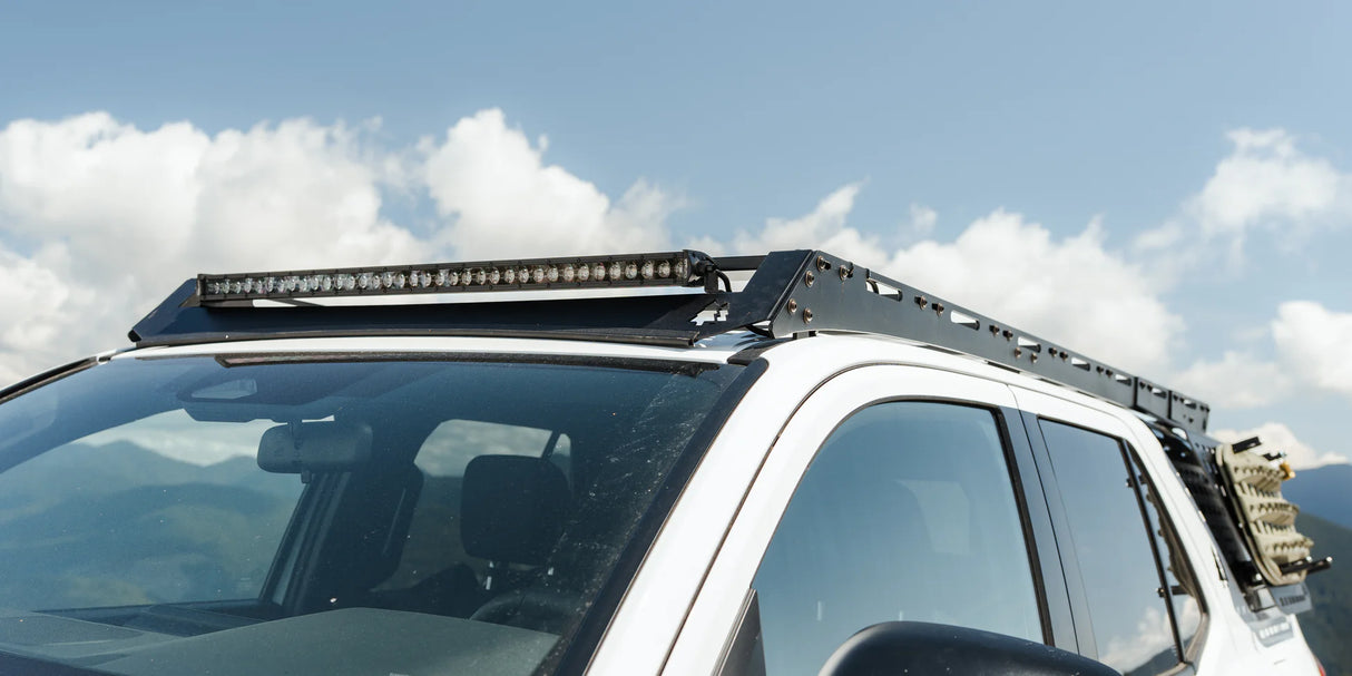 Angled view of roof rack on an SUV with a lightbar attached to it