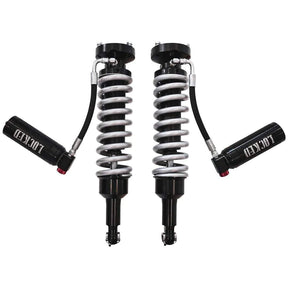Two shock absorbers with springs on a white background