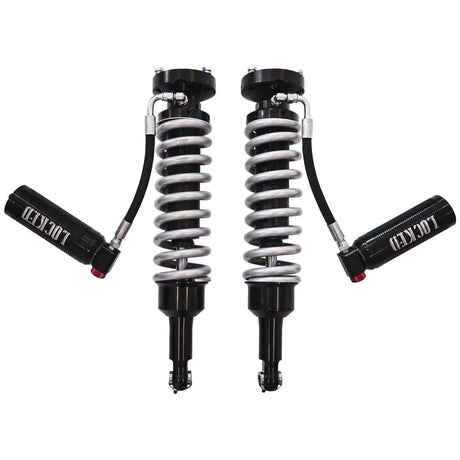 Two shock absorbers with springs on a white background
