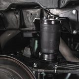 Close-up of a suspension shock absorber on a vehicle