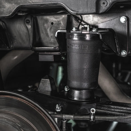 Close-up of a suspension shock absorber on a vehicle