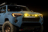 Blue Toyota SUV with illuminated headlights on a dark background