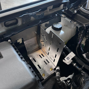 Close-up of a car's engine compartment with various components.