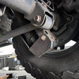Close-up of a vehicle suspension system with a tire and wheel.