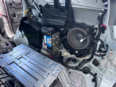 Open car panel revealing electrical components
