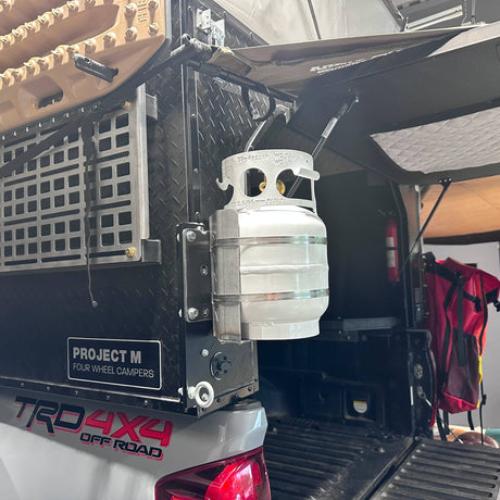 Propane tank mounted to the exterior rear of a Project M camper.