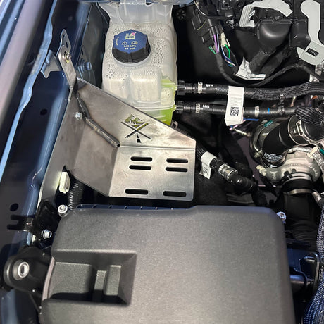 Close-up of a car's engine compartment with various components.