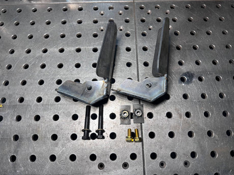 Metal brackets and screws on a perforated metal surface