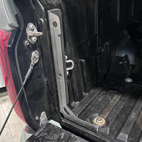 Close-up of a vehicle's open cargo area with tools and equipment inside.
