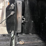 Close-up of a mechanical component on a vehicle, possibly a door mechanism.