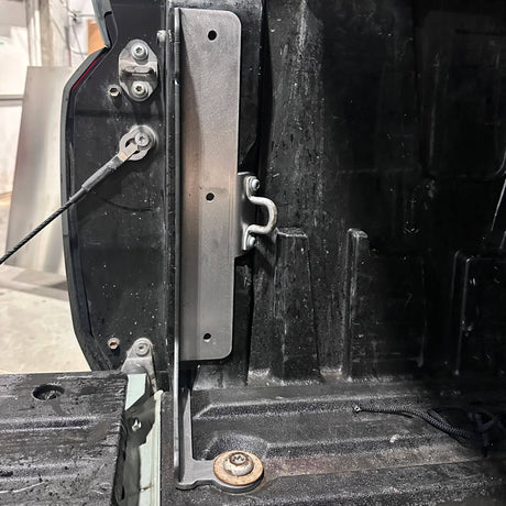 Close-up of a mechanical component on a vehicle, possibly a door mechanism.
