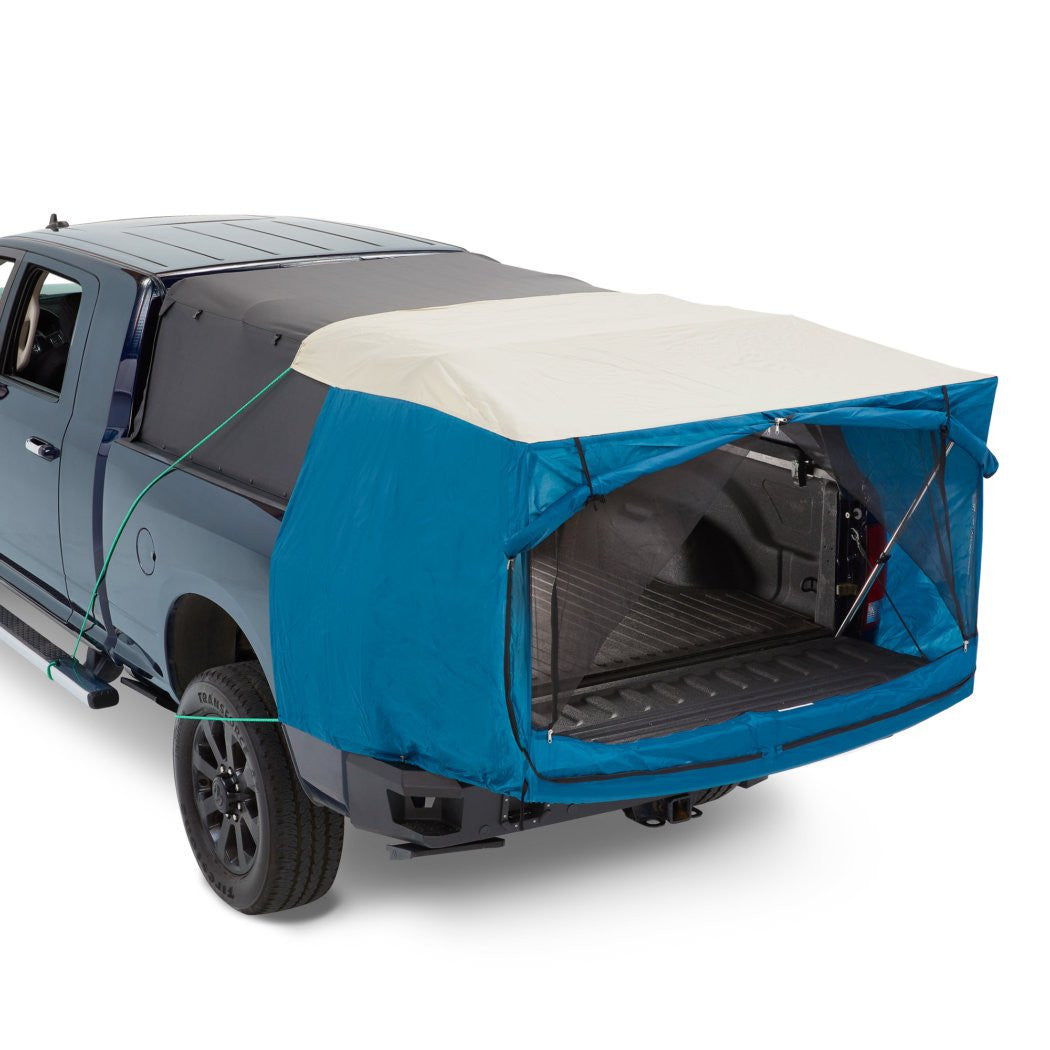 Blue truck bed cover on a gray truck with white background