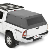 White truck with a black roof rack and gray tonneau cover on a white background