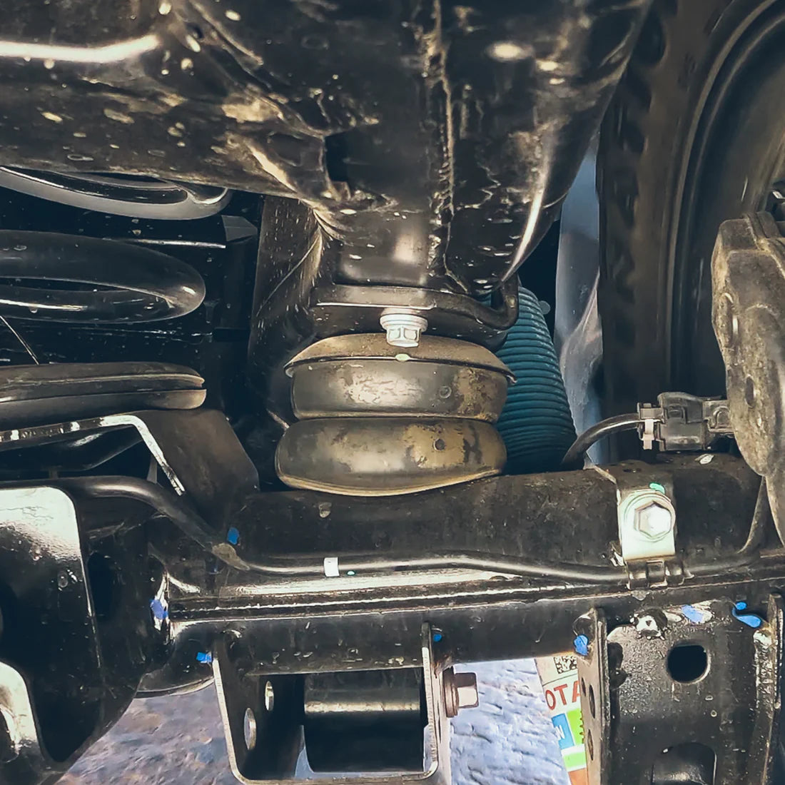 Close-up of a vehicle's suspension system with visible components.