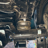 Close-up of a vehicle's suspension system with visible components.