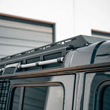 Close-up of a vehicle roof rack system on a truck with a blurred background.