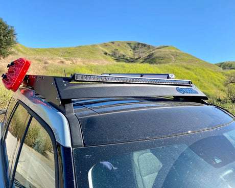 Car roof rack with lights on a vehicle in a scenic outdoor setting