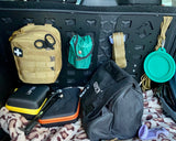 Collection of outdoor and travel gear on a vehicle's open trunk.