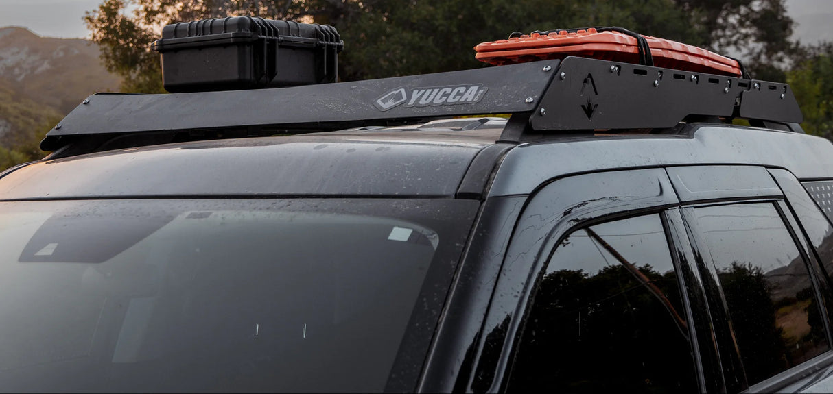 Car with a Yucca roof rack system on a mountain road