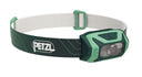 A green and white Petzl Tikkina headlamp with a compact design and adjustable headband.